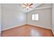 Empty bedroom featuring wood floors, ceiling fan, natural light, and shuttered windows at 7633 W Kristal Way, Glendale, AZ 85308