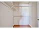 A walk-in closet with white shelving and wood floor provides ample storage space at 7633 W Kristal Way, Glendale, AZ 85308