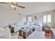 Bright living room featuring modern furniture, natural light, and ceiling fan adding comfort and appeal at 7633 W Kristal Way, Glendale, AZ 85308
