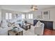 Inviting living room showcasing hardwood floors, shuttered windows, and stylish furniture, enhancing comfort at 7633 W Kristal Way, Glendale, AZ 85308