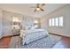 A spacious main bedroom offers plantation shutters, ceiling fan, and plush rug at 7633 W Kristal Way, Glendale, AZ 85308