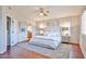 A spacious main bedroom offers plantation shutters, ceiling fan, and plush rug, and ensuite bath at 7633 W Kristal Way, Glendale, AZ 85308