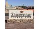 The Arrowhead Country Club sign is in front of an orange vehicle, with the Dove of the Desert Church sign in the background at 7633 W Kristal Way, Glendale, AZ 85308