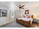 Inviting bedroom with a rustic wood bed frame, soft gray carpet, and natural lighting at 9224 N 126Th St, Scottsdale, AZ 85259