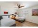Bright bedroom featuring two twin beds, wooden floors, ceiling fan, and sunny window at 9224 N 126Th St, Scottsdale, AZ 85259