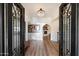 Grand entrance showcases a crystal chandelier, iron doors, and archway leading to living area at 9224 N 126Th St, Scottsdale, AZ 85259