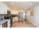 Bright, modern kitchen boasts stainless steel appliances, white cabinets, and ample storage at 9224 N 126Th St, Scottsdale, AZ 85259
