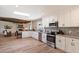 Open kitchen design with modern appliances, skylight, breakfast bar, and seamlessly connects to the living area at 9224 N 126Th St, Scottsdale, AZ 85259