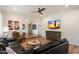 Bright living room features a large sectional sofa, ceiling fan, and hardwood flooring at 9224 N 126Th St, Scottsdale, AZ 85259