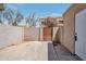 Fenced backyard showcasing a concrete slab, block fence, and private gate at 948 S Alma School Rd # 13, Mesa, AZ 85210
