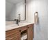 Bathroom features a modern vanity with dark fixtures and a decorative mirror at 948 S Alma School Rd # 13, Mesa, AZ 85210