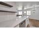 Kitchen area with white countertops and cabinets, shelving, and stainless steel dishwasher at 948 S Alma School Rd # 13, Mesa, AZ 85210