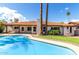 A beautiful backyard with a pool, mature trees and a grassy lawn at 9629 N 83Rd Way, Scottsdale, AZ 85258