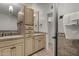 Bathroom featuring tiled walls, double sinks with cabinets and a large mirror at 9629 N 83Rd Way, Scottsdale, AZ 85258