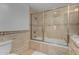 Bathroom with tiled walls, shower, bathtub and glass shower doors at 9629 N 83Rd Way, Scottsdale, AZ 85258
