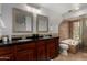 Bathroom with dual vanities, and tub, finished with tile flooring at 9629 N 83Rd Way, Scottsdale, AZ 85258