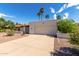 Single-story house showing the full front elevation with driveway and desert landscaping at 9629 N 83Rd Way, Scottsdale, AZ 85258