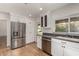 Modern kitchen features white cabinets, granite countertops, stainless steel appliances, and recessed lighting at 9629 N 83Rd Way, Scottsdale, AZ 85258