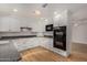 Modern kitchen features white cabinets, granite countertops, stainless steel appliances, and recessed lighting at 9629 N 83Rd Way, Scottsdale, AZ 85258