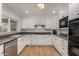 Modern kitchen features white cabinets, granite countertops, stainless steel appliances, and recessed lighting at 9629 N 83Rd Way, Scottsdale, AZ 85258