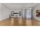 Spacious living room with brick fireplace, light hardwood floors, and a large window for natural light at 9629 N 83Rd Way, Scottsdale, AZ 85258