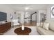 Bright living room featuring hardwood floors, modern furniture, and an open layout connecting to the kitchen at 9629 N 83Rd Way, Scottsdale, AZ 85258