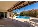 Covered patio looks out over the beautiful pool and lush backyard at 9629 N 83Rd Way, Scottsdale, AZ 85258