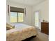 Bright bedroom with large window views, plush bedding, and door for balcony access at 16344 E Arrow Dr # B1, Fountain Hills, AZ 85268