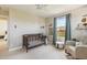 Cozy Bedroom featuring a modern crib, rocking chair and view to the neighborhood at 16498 W Gary Way, Goodyear, AZ 85338