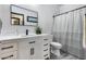 Modern bathroom featuring a vanity with sink, a framed mirror, and a shower with a striped curtain at 17451 W Hadley St, Goodyear, AZ 85338