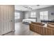 Bright bedroom features a ceiling fan, multiple windows, and wood-look flooring at 17451 W Hadley St, Goodyear, AZ 85338