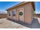 Charming home exterior features a welcoming front door with a wreath and a manicured gravel yard at 17451 W Hadley St, Goodyear, AZ 85338