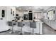 Modern kitchen boasts white cabinets, marble counters, stainless steel appliances and a breakfast bar at 17451 W Hadley St, Goodyear, AZ 85338
