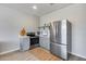 Well-lit kitchen features stainless steel appliances, gray cabinets, and bright countertops at 17451 W Hadley St, Goodyear, AZ 85338