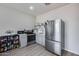 Cozy kitchen features modern appliances, including a stainless steel refrigerator, and ample countertop space at 17451 W Hadley St, Goodyear, AZ 85338