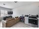 Living room and kitchen with modern appliances and a comfortable sofa that creates a cozy and functional living space at 17451 W Hadley St, Goodyear, AZ 85338