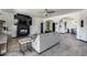 Open-concept living room with a fireplace, modern furnishings, and arched doorways at 17451 W Hadley St, Goodyear, AZ 85338