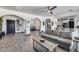 Inviting living room featuring an open layout, stylish furnishings, and elegant archways to kitchen and dining at 17451 W Hadley St, Goodyear, AZ 85338