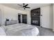 Serene main bedroom with a fireplace, ceiling fan, and an ensuite bathroom at 17451 W Hadley St, Goodyear, AZ 85338