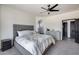 Spacious main bedroom featuring a luxurious bed, neutral color scheme, and a well-lit ensuite bathroom at 17451 W Hadley St, Goodyear, AZ 85338