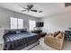 This bright main bedroom features a comfortable seating area and a ceiling fan for added comfort at 17451 W Hadley St, Goodyear, AZ 85338