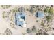 Aerial view of the property featuring a large house, a detached garage, solar panels, and desert landscaping at 3215 N 83Rd St, Mesa, AZ 85207