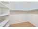 Walk-in closet featuring custom shelving and ample storage space, providing an organized wardrobe solution at 3215 N 83Rd St, Mesa, AZ 85207