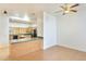 Kitchen featuring a breakfast bar, light wood cabinets, and black appliances at 3215 N 83Rd St, Mesa, AZ 85207