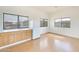 Bright kitchenette with wood cabinets, white appliances, and a window overlooking the landscape at 3215 N 83Rd St, Mesa, AZ 85207