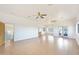 Spacious living room with hardwood floors, white walls, ceiling fans, and natural light from large windows at 3215 N 83Rd St, Mesa, AZ 85207