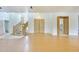 Open-concept living space featuring wood floors, a winding staircase and a double-door entryway at 3215 N 83Rd St, Mesa, AZ 85207