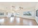 Bright and airy living room featuring wood floors, abundant natural light, and scenic views from the windows at 3215 N 83Rd St, Mesa, AZ 85207