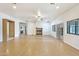 Open living area featuring wood floors, a fireplace, and neutral walls with natural lighting at 3215 N 83Rd St, Mesa, AZ 85207