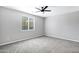 Bright bedroom with carpet, a ceiling fan, and a window allowing natural light at 35733 W Santa Monica Ave, Maricopa, AZ 85138